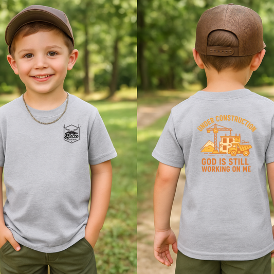👷 Under Construction Kids Tee – “God is Still Working on Me”